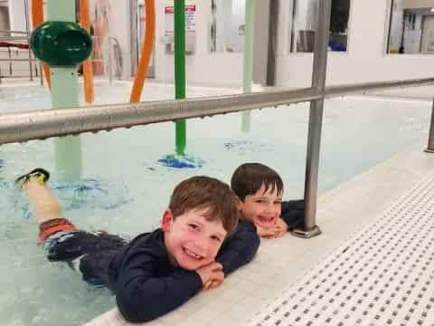 two boys lying on a trampoline