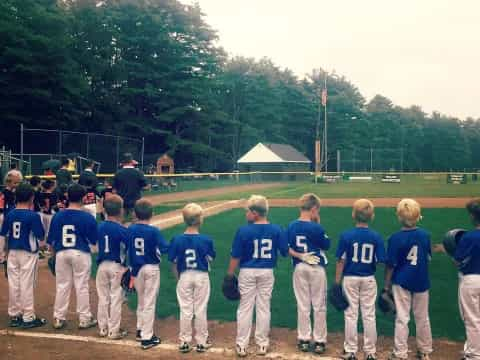 a group of baseball players standing on a field