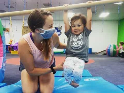 a person and a child in a gym