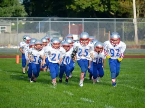 a group of kids in football gear
