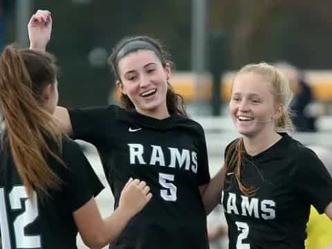 a group of women in black shirts