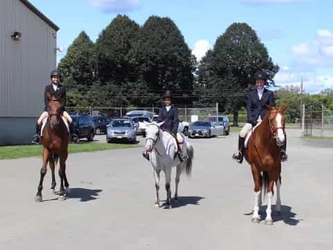 a group of people ride horses