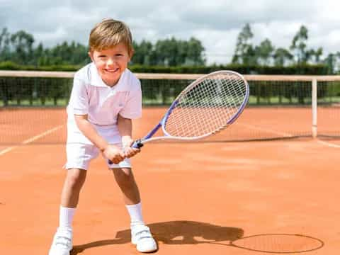 a boy holding a tennis racket