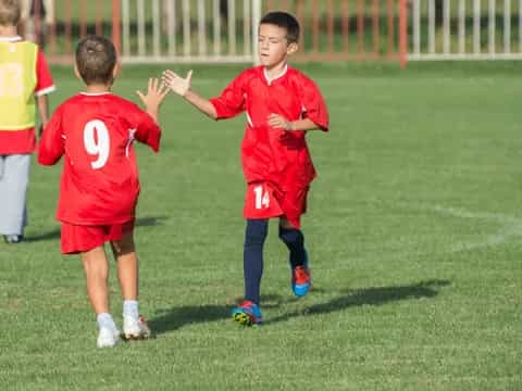 a group of kids playing football