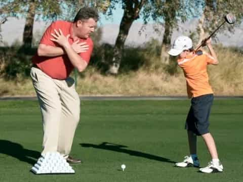 a man and a woman playing golf