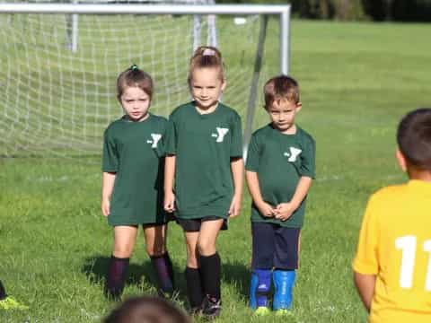 a group of kids in green uniforms