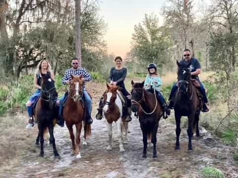 a group of people riding horses