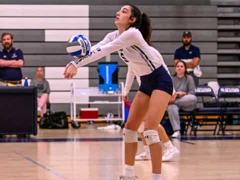 a person hitting a volleyball with the head