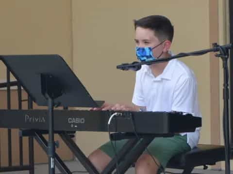 a boy playing a piano