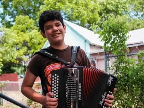 a man holding an accordion