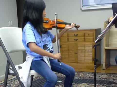 a woman playing a violin