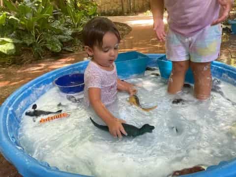a child playing in a pool