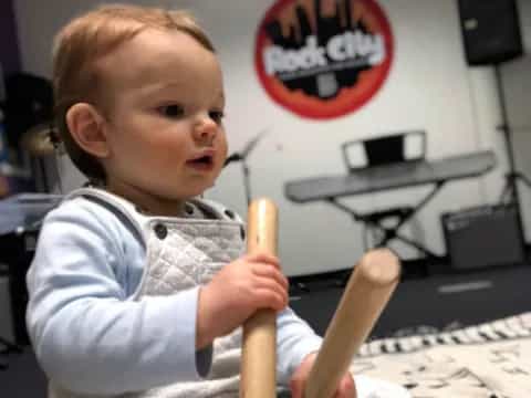 a baby holding a banana