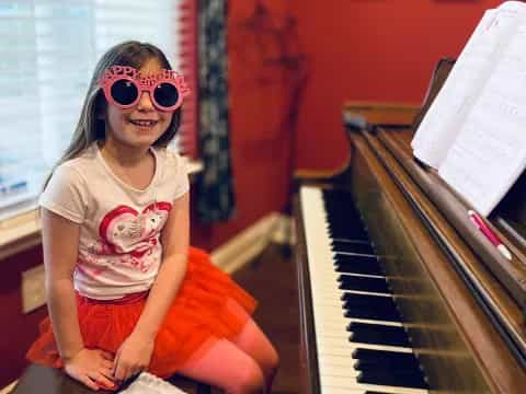 a person sitting on a piano