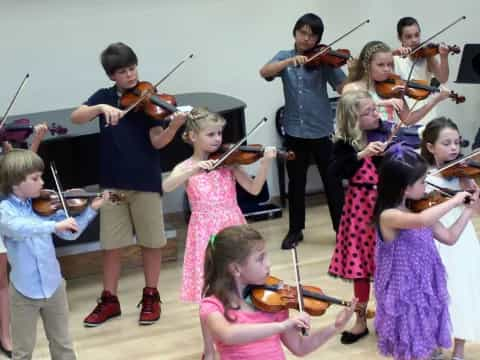 a group of children playing instruments