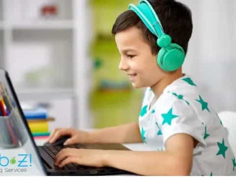 a young boy using a laptop