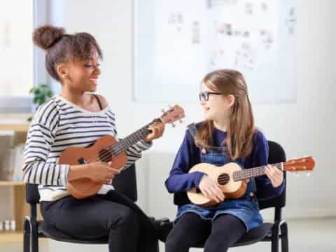 a man and a woman playing guitars