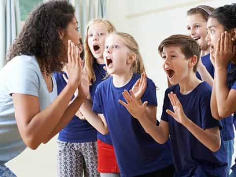 a group of children clapping