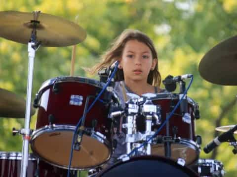 a girl playing the drums