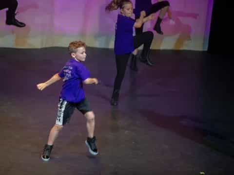 a boy running on a stage
