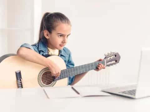 a girl playing a guitar