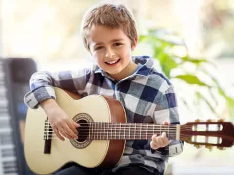 a boy playing a guitar