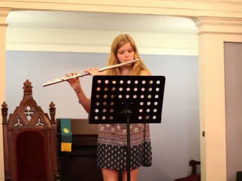 a woman holding a flute