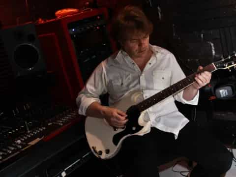 a man playing a guitar