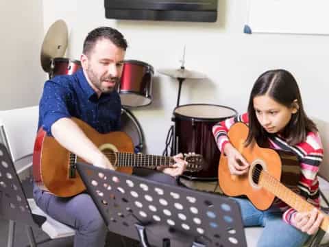 a man and a woman playing guitars
