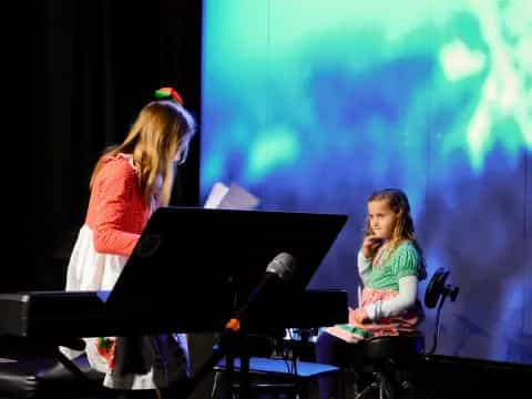 a person and a girl on a stage