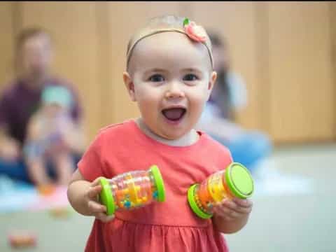 a baby holding toys