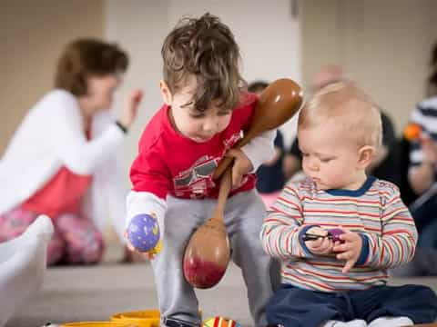 a few children sitting on the floor