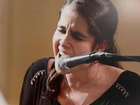 a woman singing into a microphone