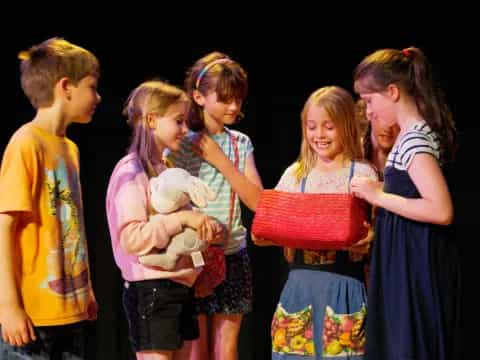 a group of children holding a stuffed animal