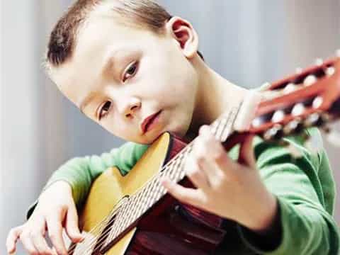 a boy holding a guitar