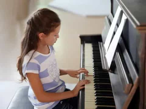 a girl playing a piano