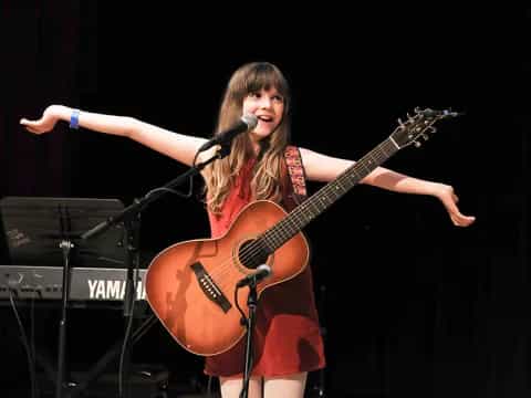 a woman playing a guitar
