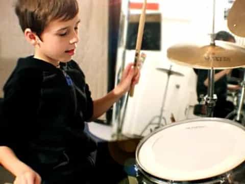 a boy playing drums