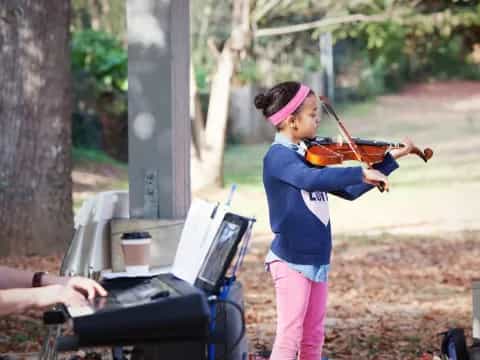 a girl playing a violin