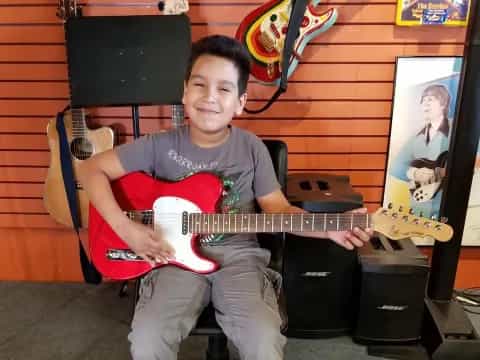 a boy holding a guitar