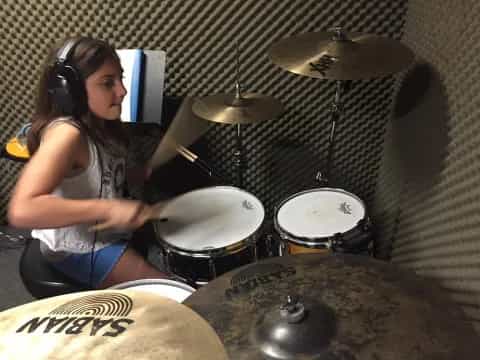 a woman playing drums
