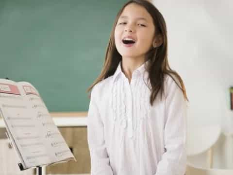 a girl holding a piece of paper