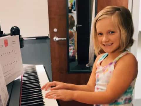 a girl playing a piano