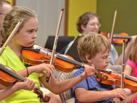 a group of kids playing violin