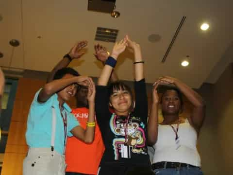 a group of people raising their hands