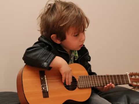 a boy playing a guitar