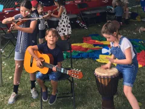 a group of kids playing instruments