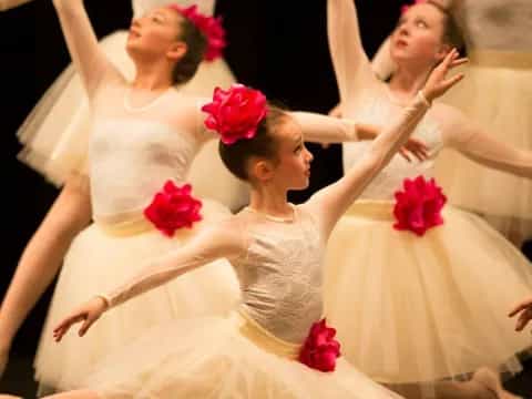 a group of women in white dresses