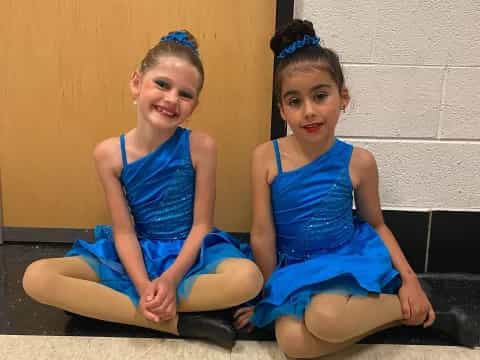 two girls in blue dresses