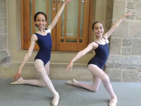 two women in blue leotards